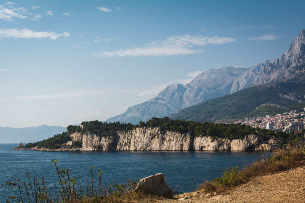 Seascape photo of rocks rising from the sea - peninsula in Makarska, Croatia.