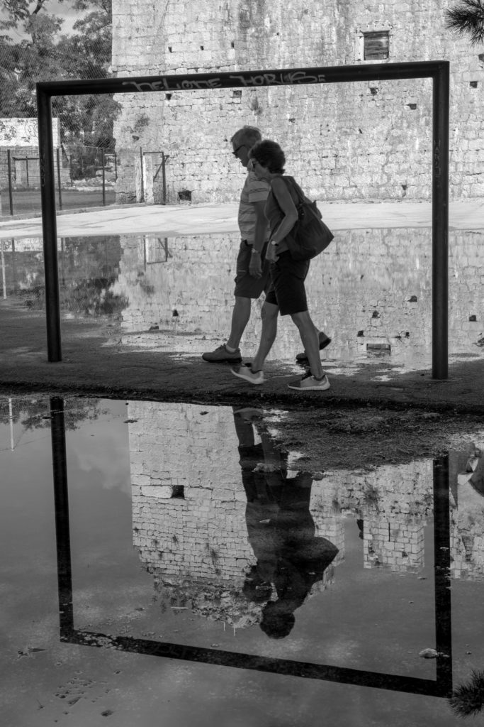 A pair of turists walking in Trogir, city in Croatia.