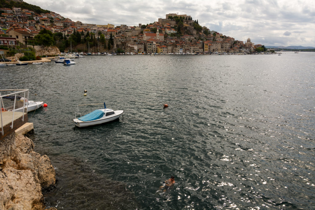 Panorama with the sea, the boat and the town of Sibenik in the background. 
