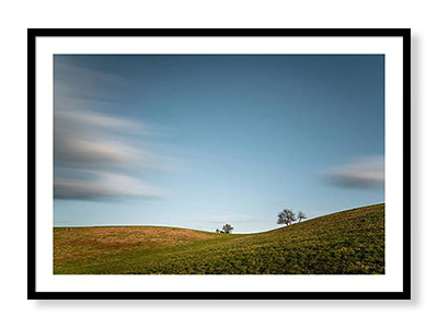 Framed photographs of landscapes for sale.