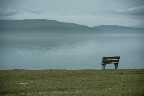 Fine art photography of a wooden bench on the shore of Khovsgol Lake in Mongolia