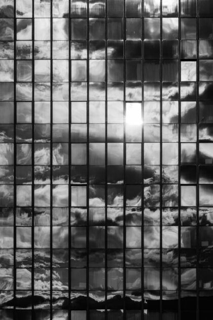 Reflective skyscraper with clouds - Abstract