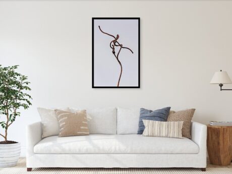 Vine Dancer fine art print framed above a sofa in a bright modern living room - Abstract