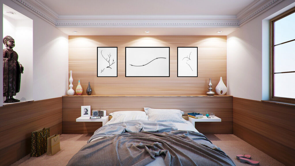 A visualization of a set of three minimalist botanical photographs in a calm bedroom.